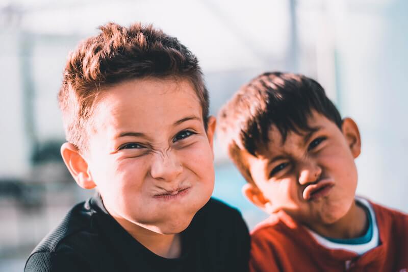 Two boys pulling whacky faces